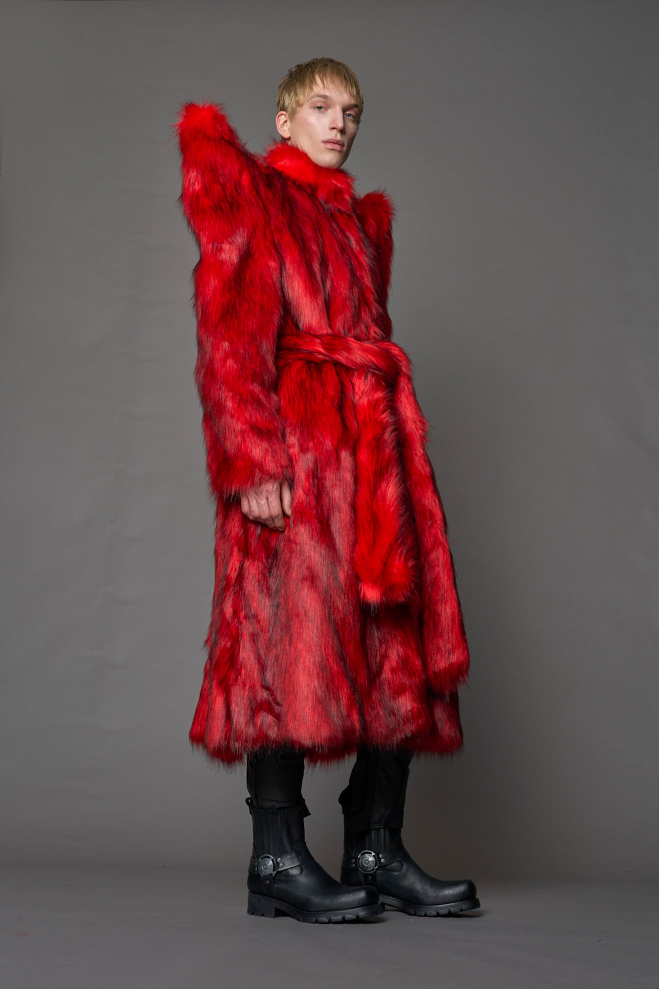 model wearing red spike shoulder long faux fur coat