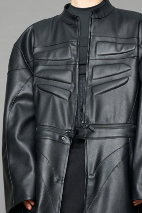 Detachable moto long coat in black vegan black leather inspired by a deconstructed full-body motocross racing suit, featuring padded panel details and a detachable zip design for two-way wear.