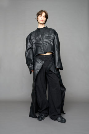 Detachable moto long coat in black vegan black leather inspired by a deconstructed full-body motocross racing suit, featuring padded panel details and a detachable zip design for two-way wear.