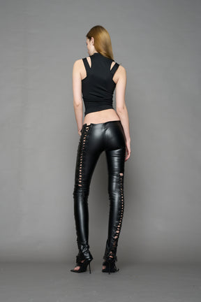 Model wearing Black faux leather lace-up pants with adjustable side lacing