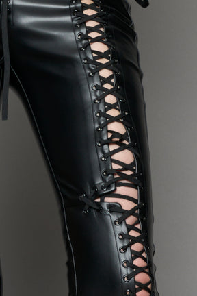 Model wearing Black faux leather lace-up pants with adjustable side lacing
