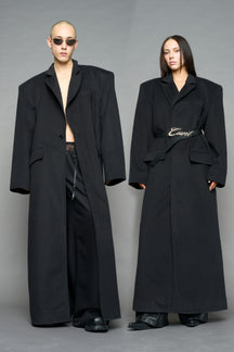 Model wearing long black coat with lapel in wool blend
