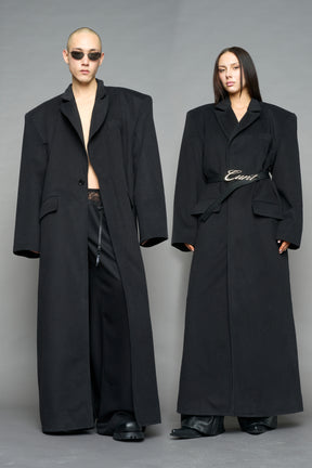 Model wearing long black coat with lapel in wool blend