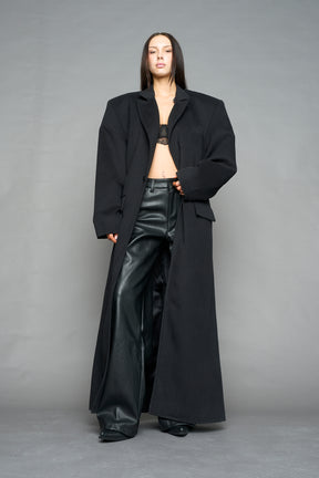 Model wearing long black coat with lapel in wool blend