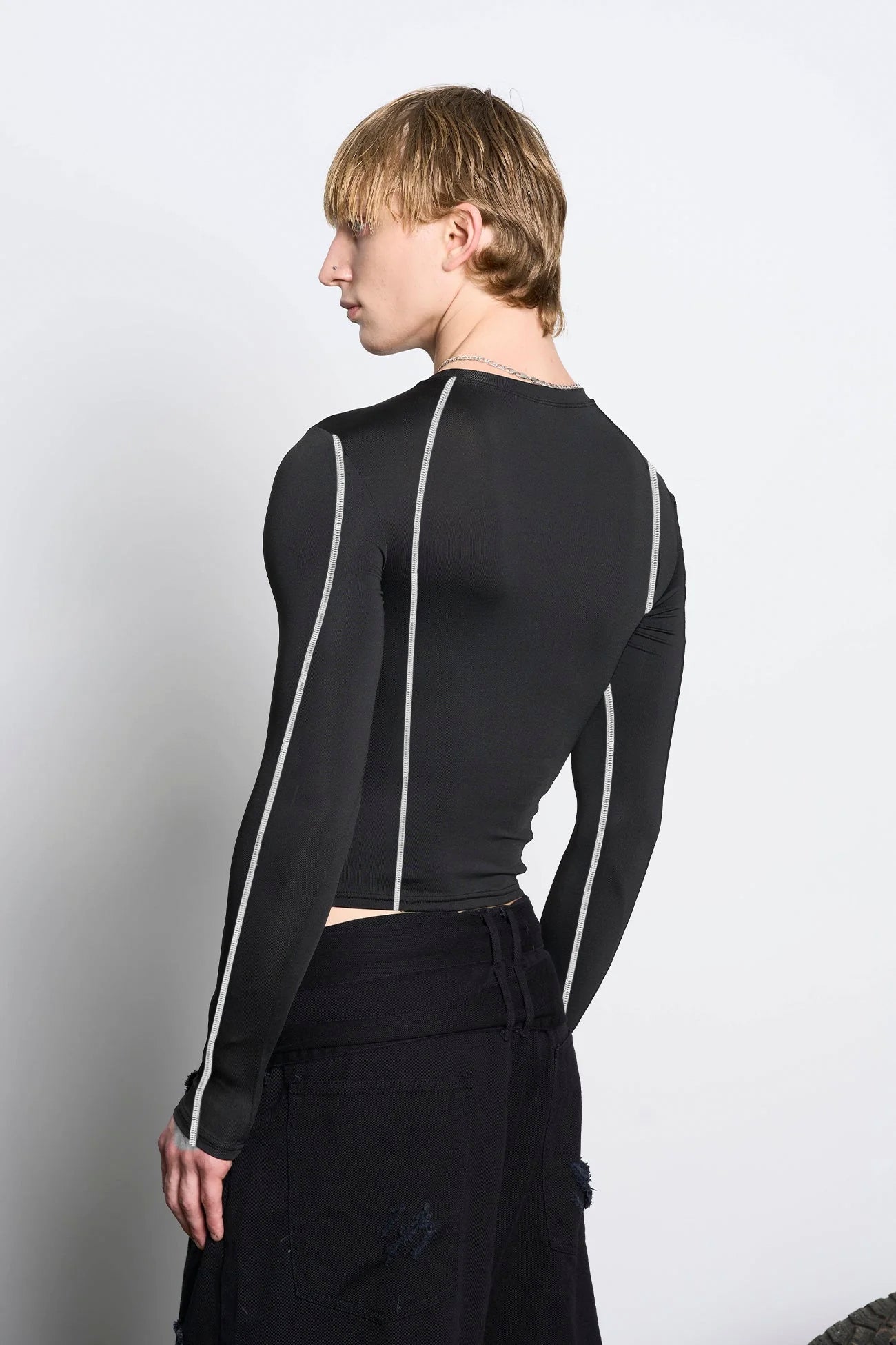 male model wearing black lycra longsleeve with rhinestone crystal slogan