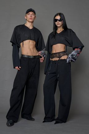 male and female model wearing a black cropped football inspired T-Shirt with a goth-inspired print