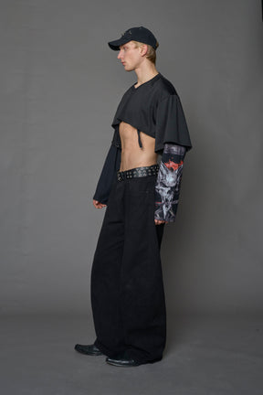 male model wearing a black cropped football inspired T-Shirt with a goth-inspired print