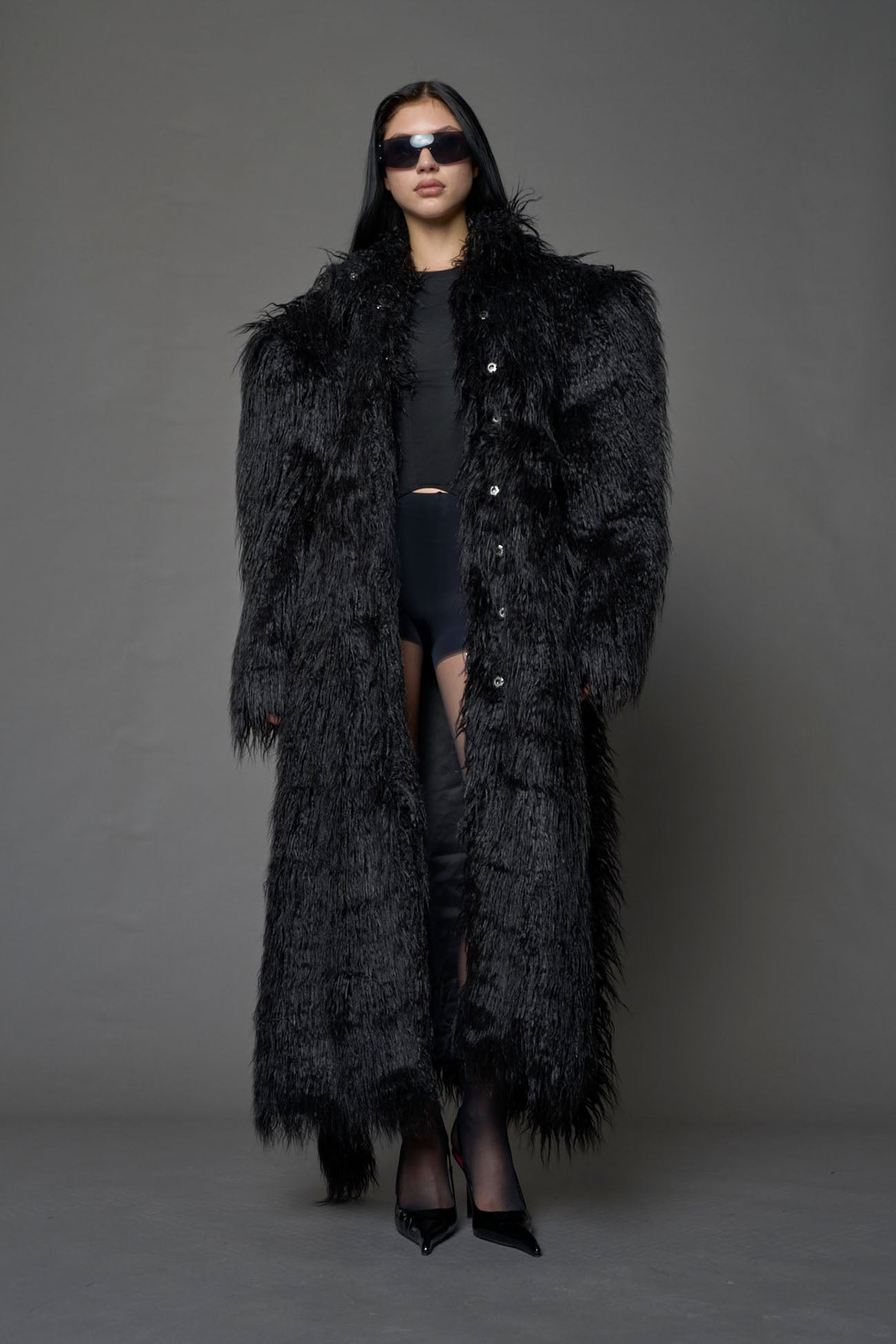 black faux fur coat with shoulder pads and  belt