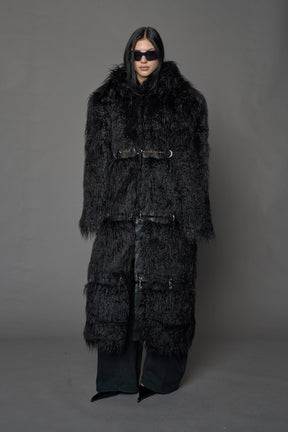 model wearing black faux fur coat with silver metal rings