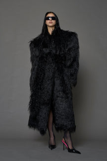 black faux fur coat with shoulder pads and  belt