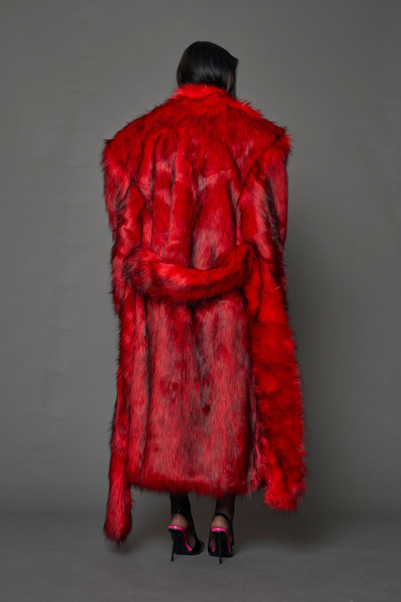 red faux fur coat with shoulder pads and  belt
