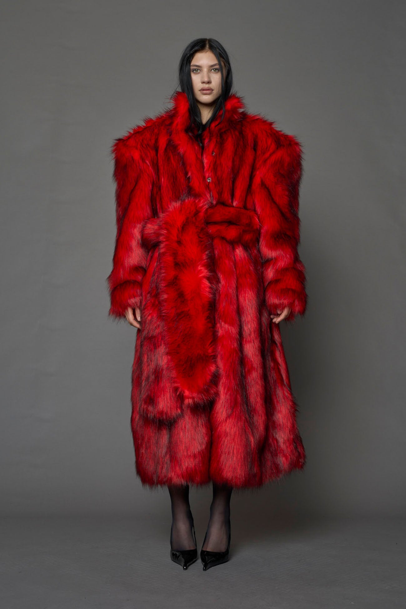 red faux fur coat with shoulder pads and  belt