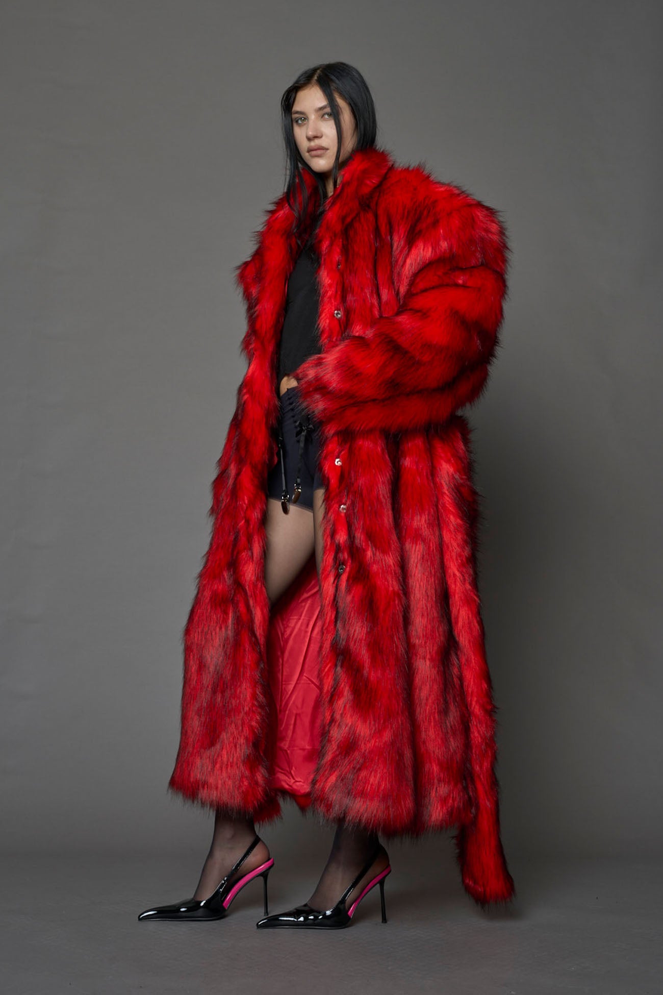 red faux fur coat with shoulder pads and  belt