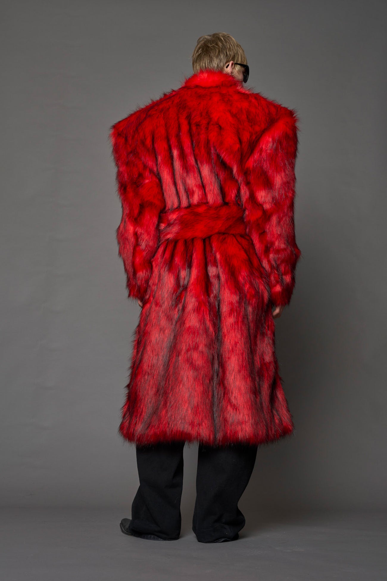 red faux fur coat with shoulder pads and  belt