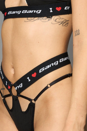 Black Namilia thong with strappy cut-out front, metal ring details and elastic waistband