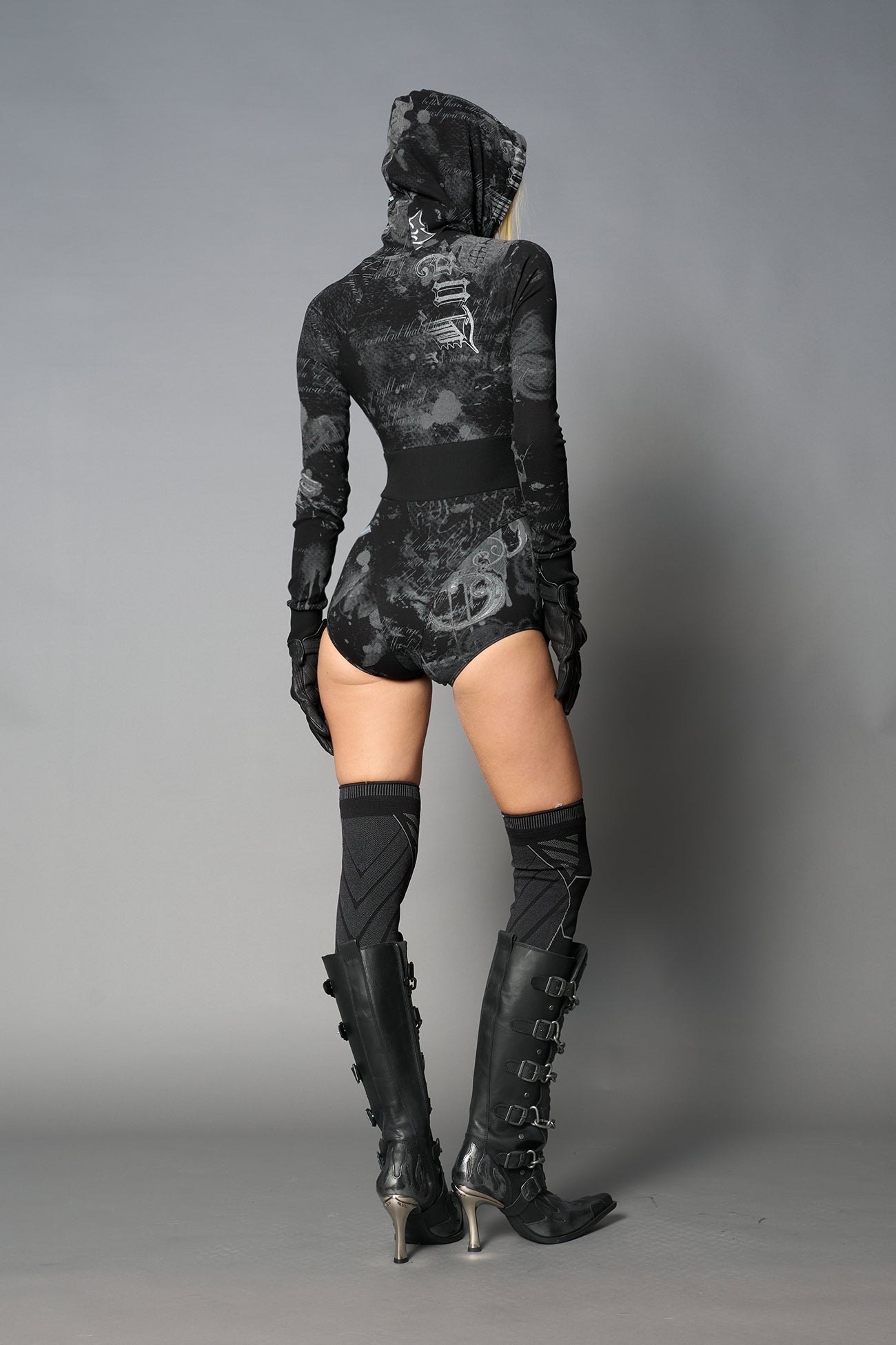 model wearing soft jersey black print bodysuit with longsleeves and drawstring hood