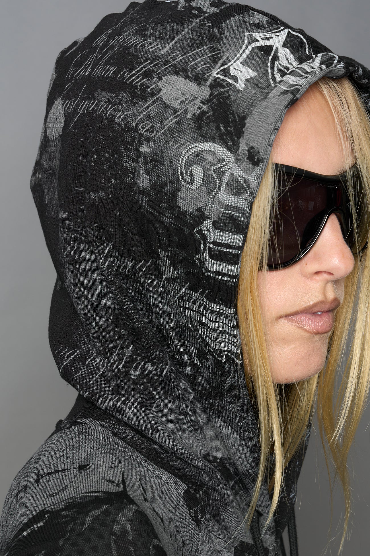 model wearing soft jersey black print bodysuit with longsleeves and drawstring hood