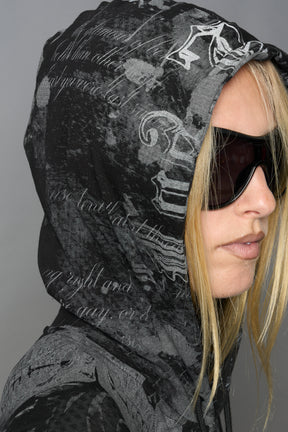 model wearing soft jersey black print bodysuit with longsleeves and drawstring hood