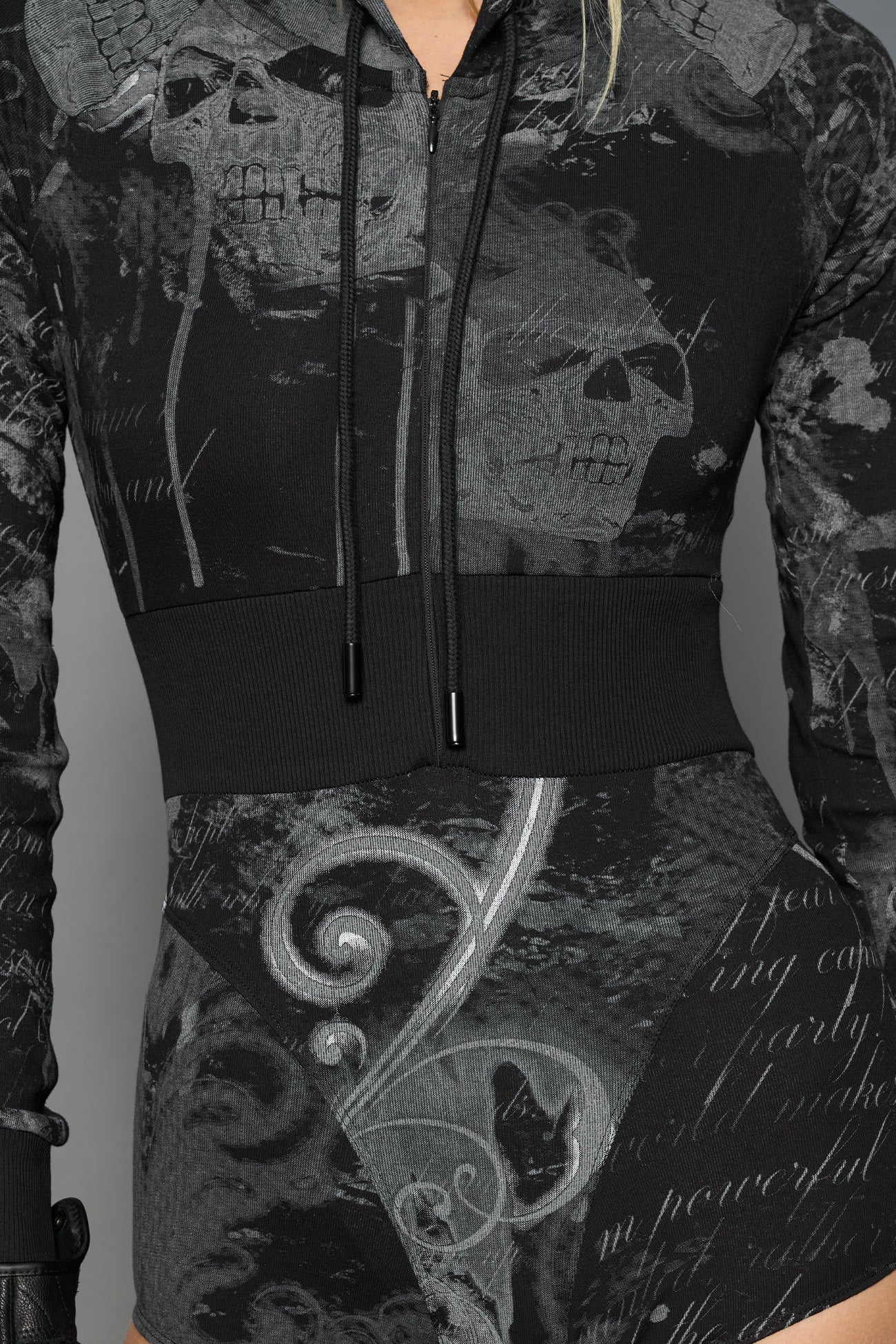 model wearing soft jersey black print bodysuit with longsleeves and drawstring hood