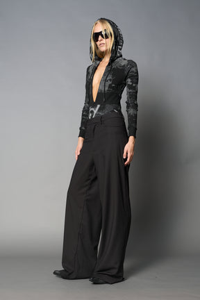 model wearing soft jersey black print bodysuit with longsleeves and drawstring hood