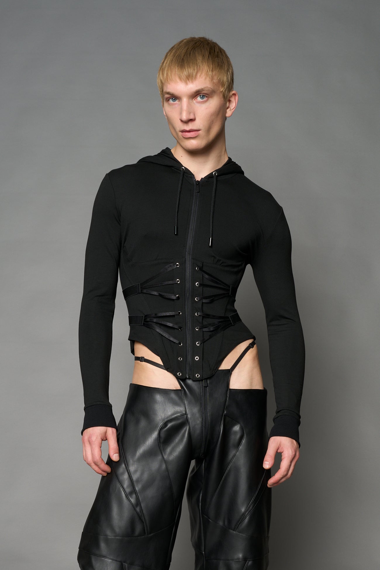 Black Namilia zip-up hoodie with built-in corset, lace-up front, cut-out sides and drawstring hood