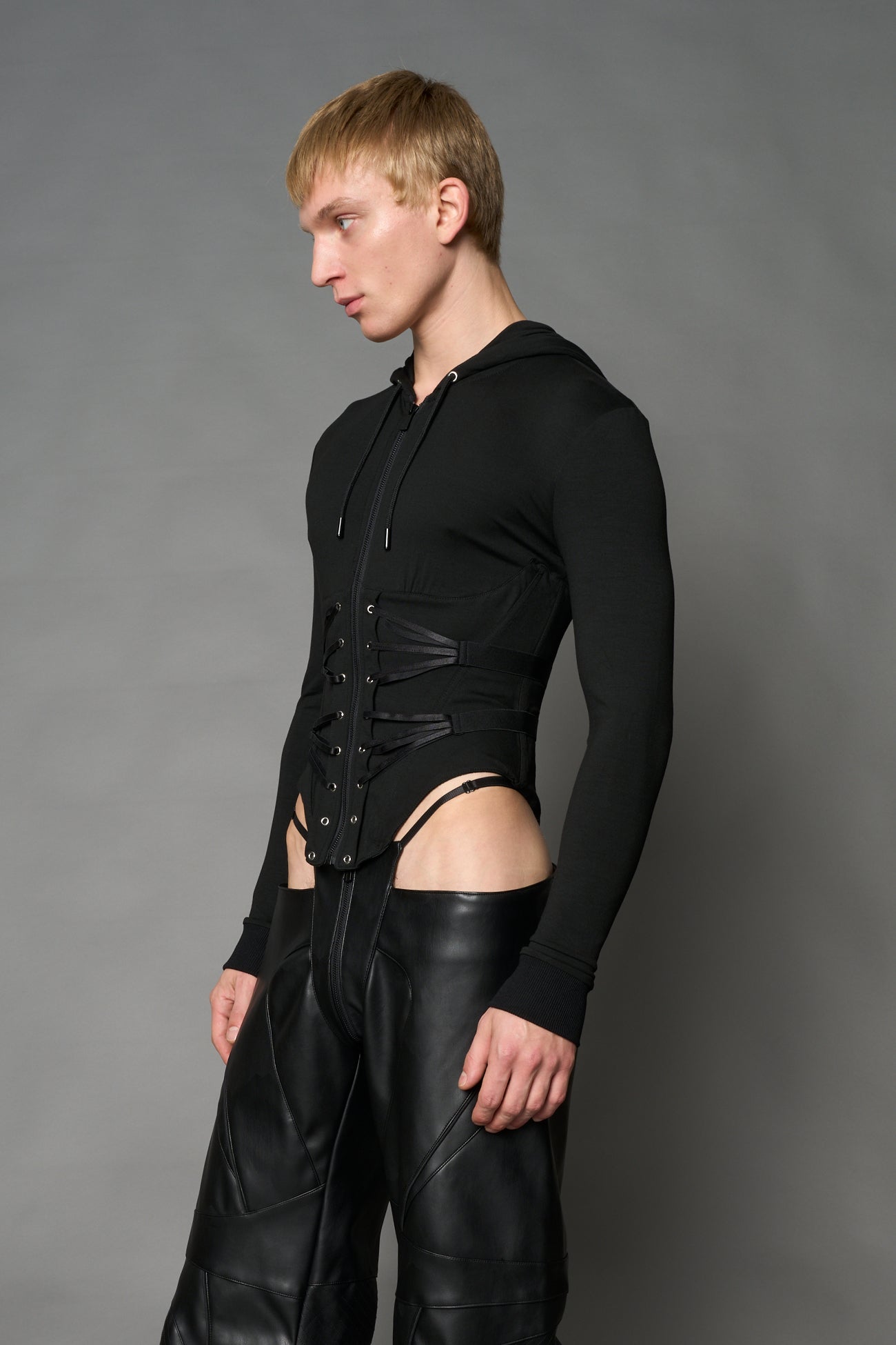Black Namilia zip-up hoodie with built-in corset, lace-up front, cut-out sides and drawstring hood
