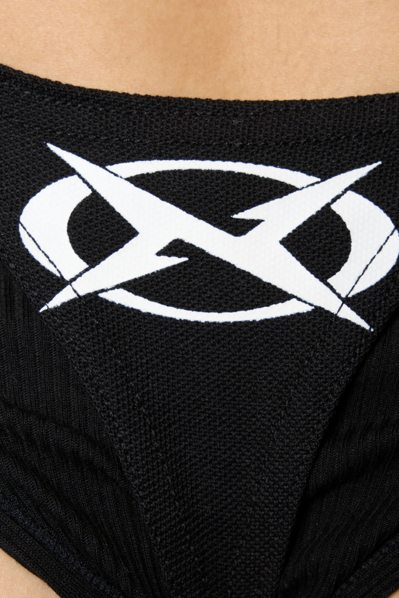 Black Namilia polo bodysuit with biker graphic print, cut-out sides, O-ring strap details and thong back with X logo