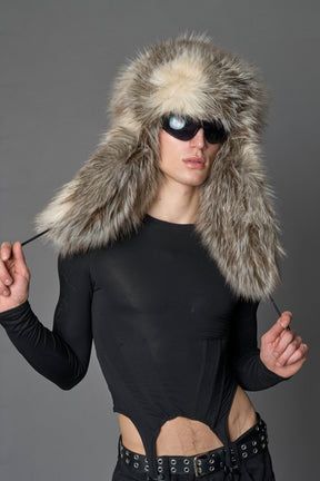 Model wearing oversized brown and cream faux-fur hood hat with drawstrings