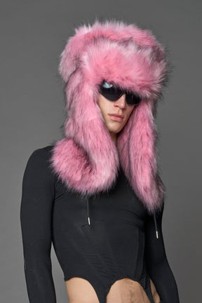 Model wearing oversized pink and cream faux-fur hood hat with drawstrings