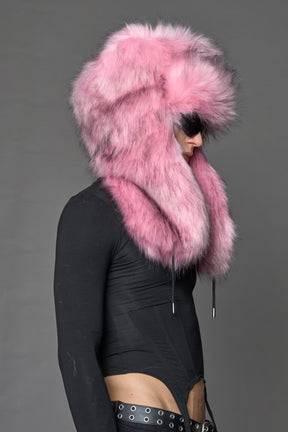 Model wearing oversized pink and cream faux-fur hood hat with drawstrings