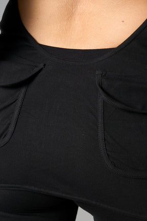model wearing black soft jersey short dress with hood and backless cut out
