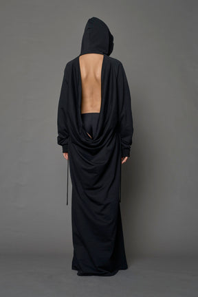 Model wearing a long black hoodie dress with a goth-inspired print detail