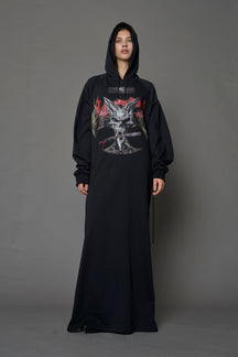 Model wearing a long black hoodie dress with a goth-inspired print detail