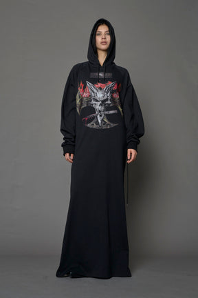 Model wearing a long black hoodie dress with a goth-inspired print detail