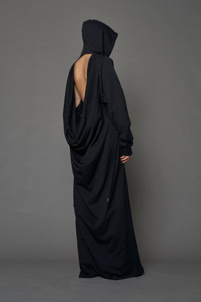 Model wearing a long black hoodie dress with a goth-inspired print detail