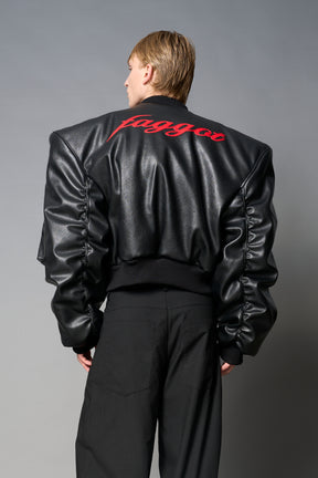model wears red oversize cropped vegan leather bomber with exaggerated shoulderpads and ruching on sleeves.