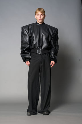 model wears red oversize cropped vegan leather bomber with exaggerated shoulderpads and ruching on sleeves.