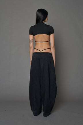 Model wearing a black form fitted T-Shirt bodysuit with lace details