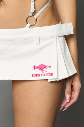 White ultra-mini pleated skirt with low-rise waist, belt loops, raw hem detailing and deconstructed tailoring by Namilia.