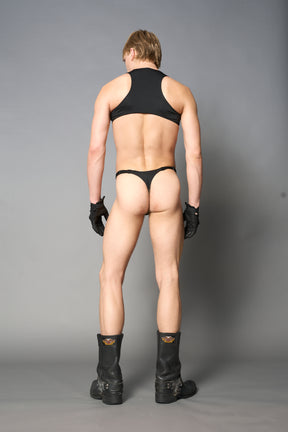 male model wearing cut out body pouch green in vegan leather with stretch lycra pants