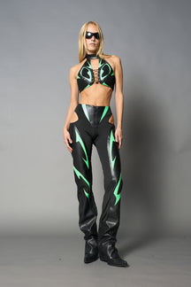 Green cut-out flare pants with graphic details, vegan leather panels, and low-rise waist – edgy motocross-inspired trousers for men’s streetwear or festival looks.