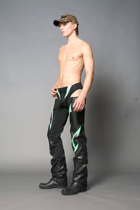 Green cut-out flare pants with graphic details, vegan leather panels, and low-rise waist – edgy motocross-inspired trousers for men’s streetwear or festival looks.