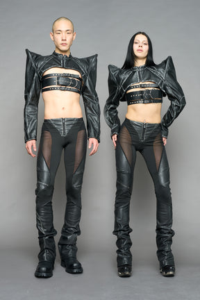 Model wearing high-waisted black washed vegan leather pants with mesh cutouts, moto-inspired paneling, and flared stacked legs – edgy streetwear trousers styled with chunky platform boots