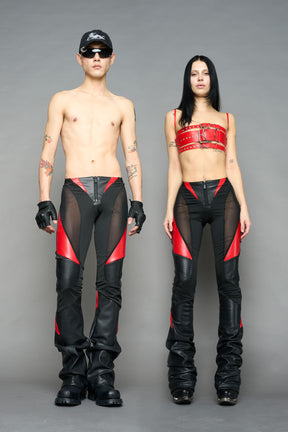 Model wearing high-waisted black red vegan leather pants with mesh cutouts, moto-inspired paneling, and flared stacked legs – edgy streetwear trousers styled with chunky platform boots