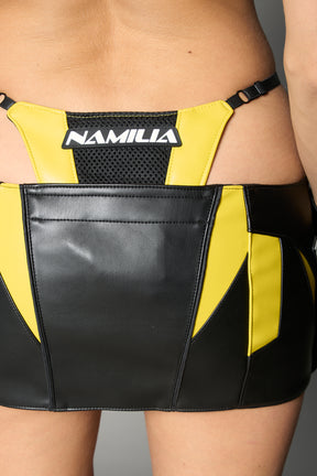 yellow vegan leather moto thong mini skirt with lace-up sides, cut-out hips, and zip front – edgy Y2K streetwear skirt for clubwear or festival looks.
