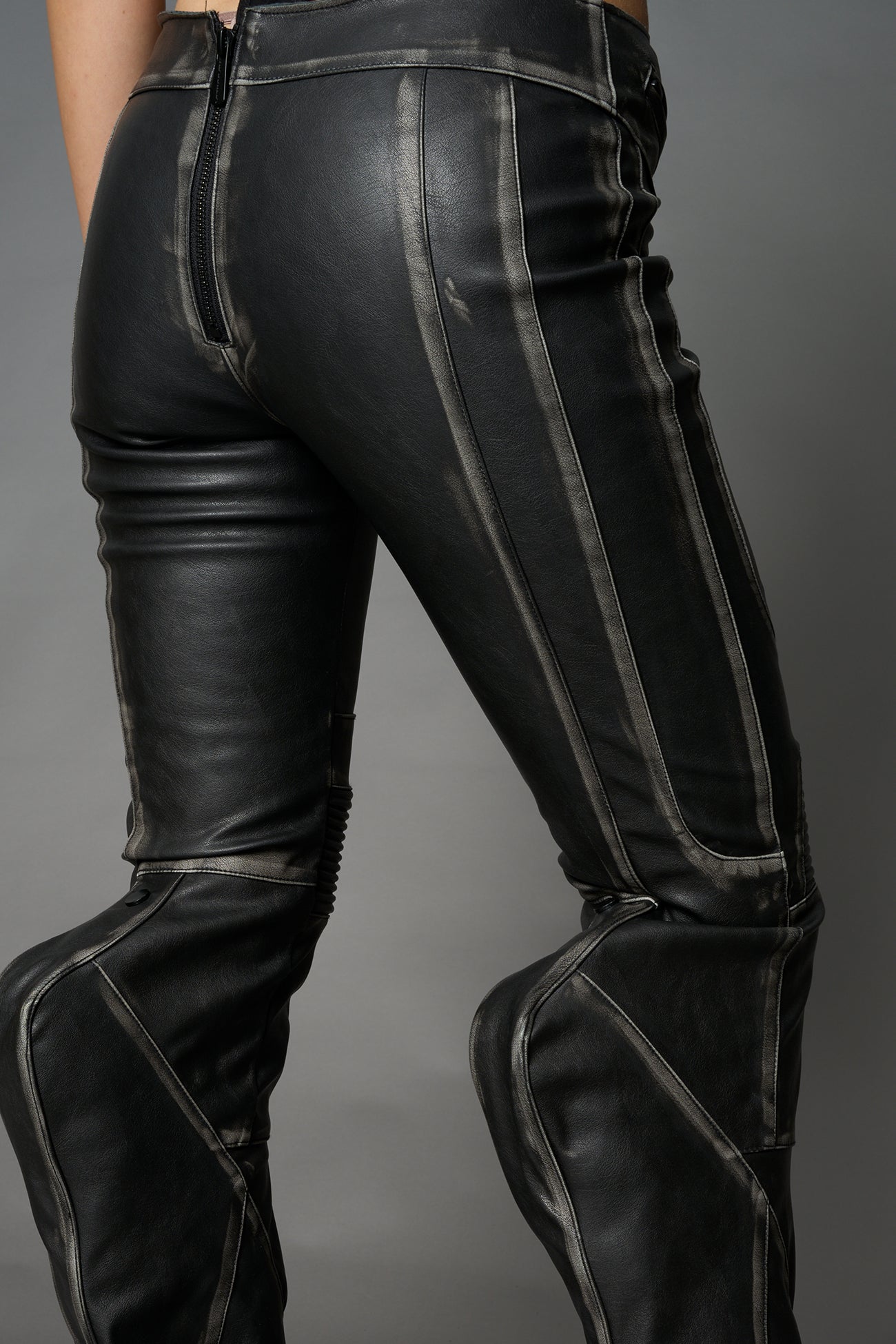 Black washed vegan leather stretch mutant pants with high waist, ribbed knee panels, and exaggerated flared legs by Namilia
