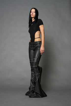 Black washed vegan leather stretch mutant pants with high waist, ribbed knee panels, and exaggerated flared legs by Namilia