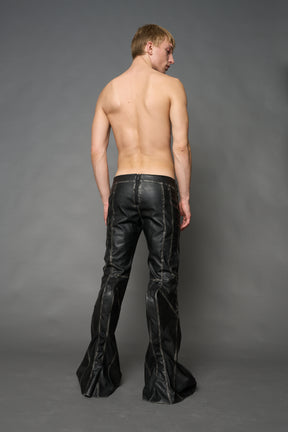 Black washed vegan leather stretch mutant pants with high waist, ribbed knee panels, and exaggerated flared legs by Namilia
