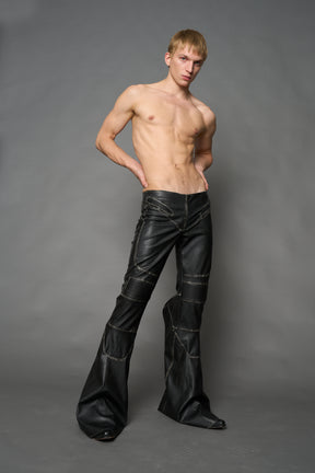 Black washed vegan leather stretch mutant pants with high waist, ribbed knee panels, and exaggerated flared legs by Namilia