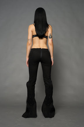 Black cotton stretch mutant pants with low waist, ribbed knee panels, and exaggerated flared legs by Namilia
